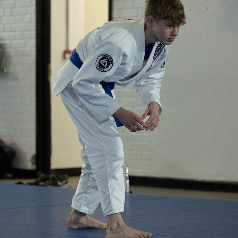 Roger Gracie Bristol assistant kids coach getting ready to show the kids what technique they will be doing.